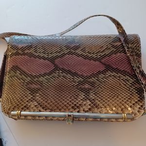 Snakeskin print bag very sturdy with metal frame inside flip closure